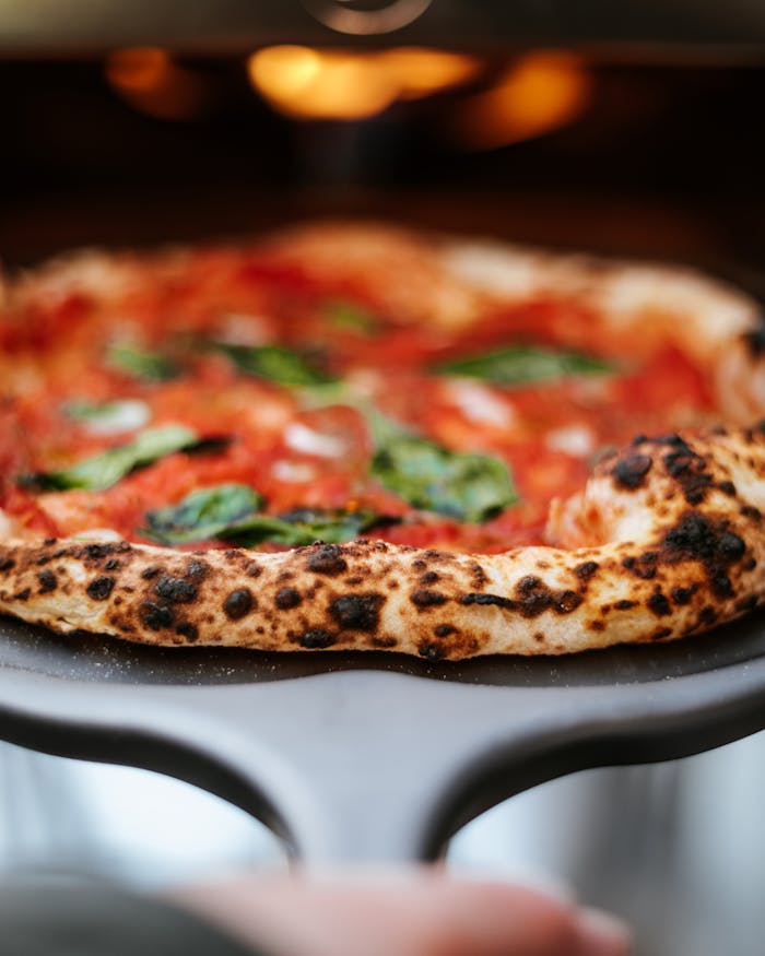 The Art of Drawing Readers In: Your attractive post title goes here Close-up of a fresh Neapolitan pizza with vibrant toppings and a crispy crust straight from the oven.